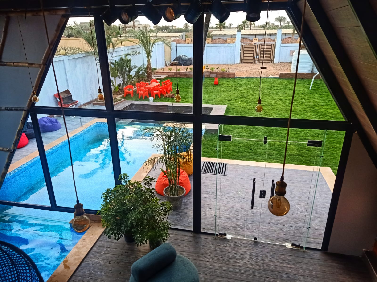 Panoramic view of pool and garden from inside the cabin